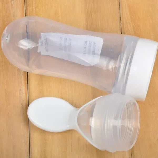 Clear plastic bottle with a white cap on a wooden surface