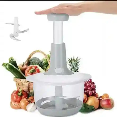 Handheld vegetable chopper with fruits and vegetables in the background