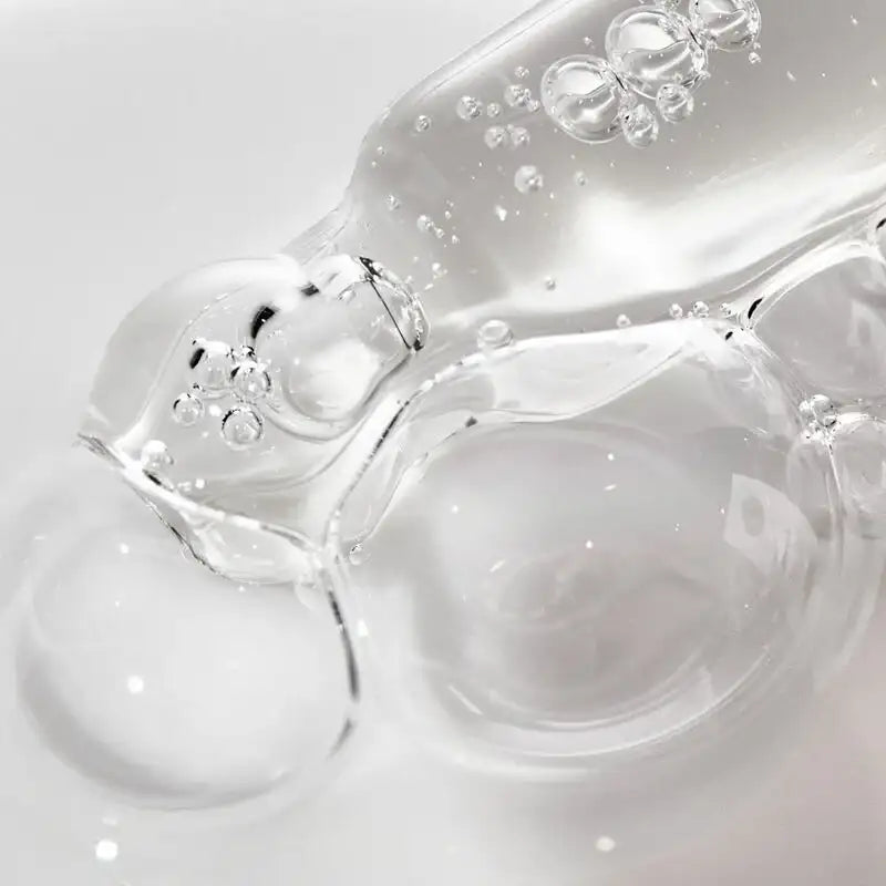 Close-up of clear gel with bubbles on a light gray background
