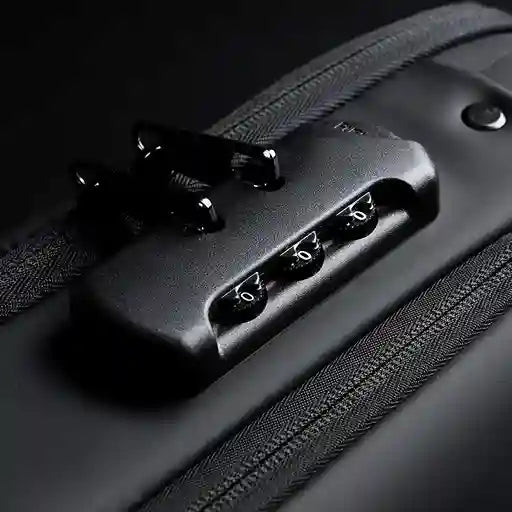 Close-up of a black suitcase handle with a dark background