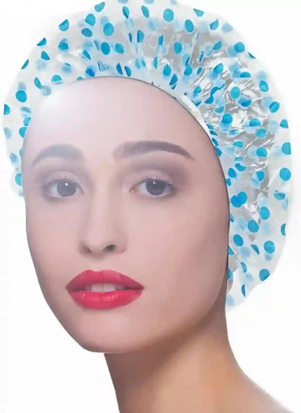 Woman wearing a blue and white polka dot shower cap on a white background