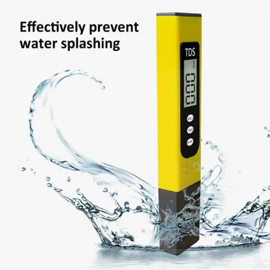 Yellow TDS meter with water splashing around it on a white background