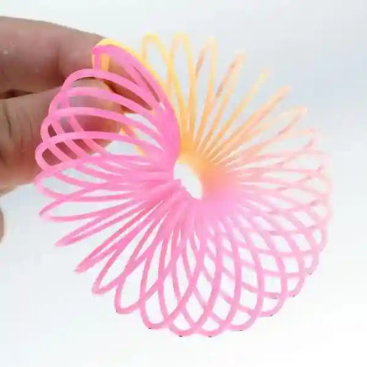 Pink and orange spring toy on a white background