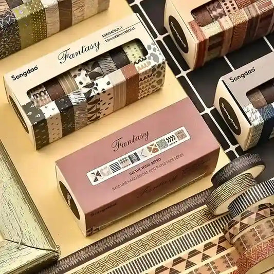 Packaged stationery items with 'Fantasy' branding on a patterned surface.