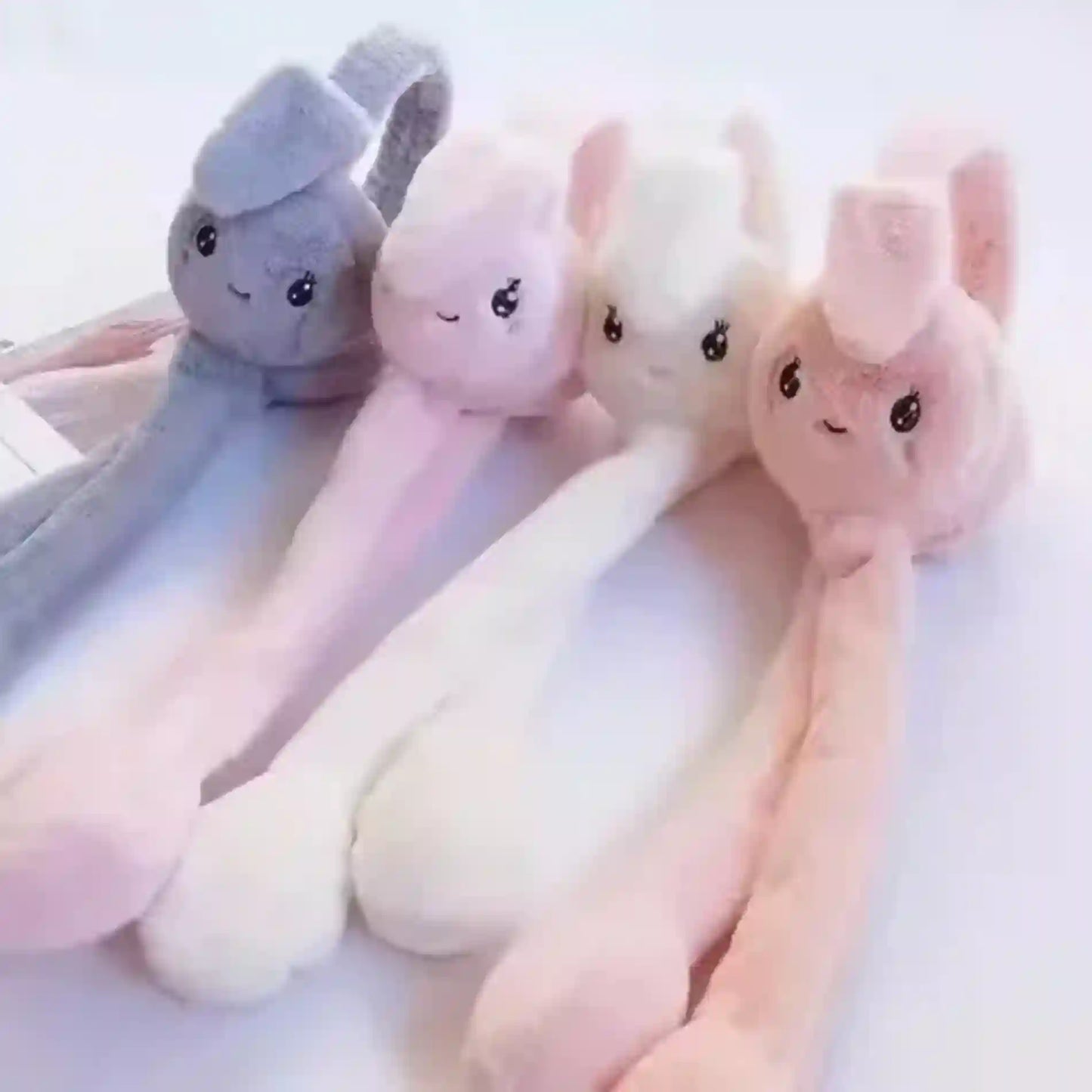 Set of plush toys resembling animals on a white background