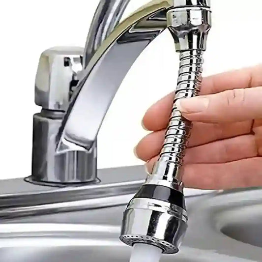 Person holding a chrome kitchen faucet extension in front of a sink.