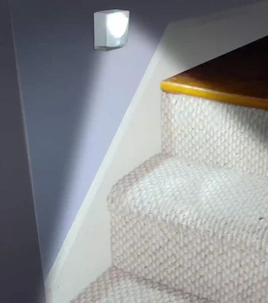 Stair light fixture on a carpeted staircase
