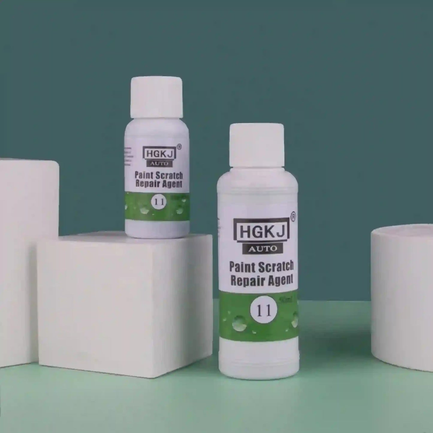 Two bottles of HGKJ AUTO Paint Scratch Repair Agent on a green and blue gradient background.