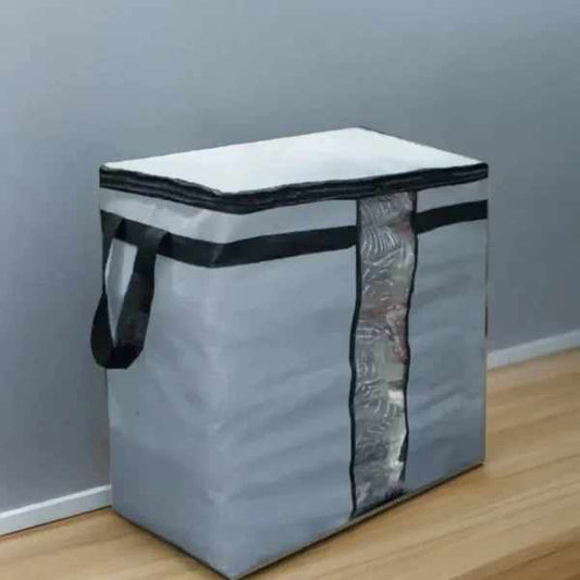 Gray storage bag with black trim on a wooden floor against a gray wall