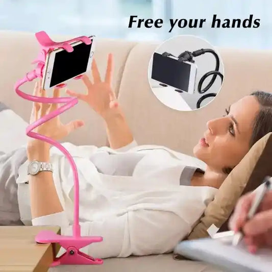 Woman using a pink phone holder on a couch with text 'Free your hands'.