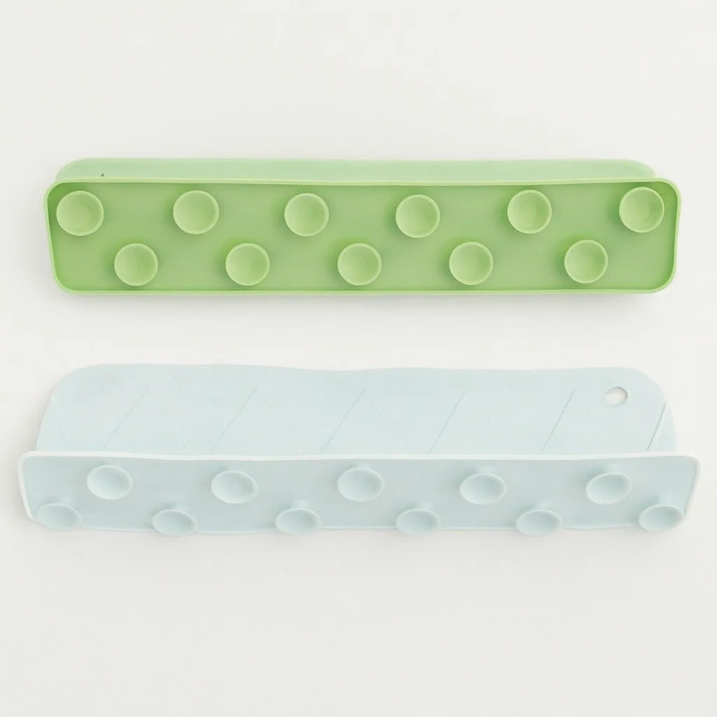 Two green and light blue rectangular objects with circular patterns on a white background