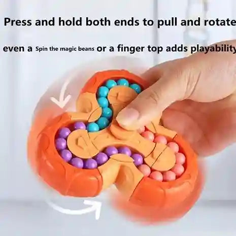 Fidget spinner with colorful beads being manipulated by a hand on a light background
