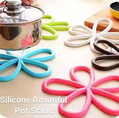Silicone pot stands in various colors on a light surface