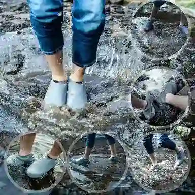 Children's feet in rain boots splashing in water with multiple reflections.