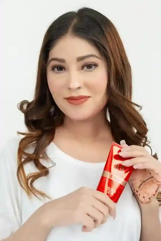 Woman holding a red product package against a white background