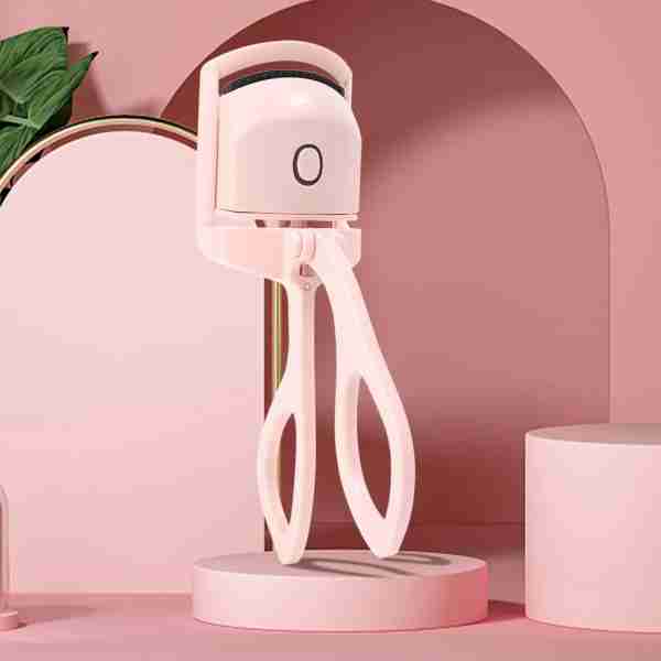 White jellyfish-shaped lamp on a pink platform with a pink background