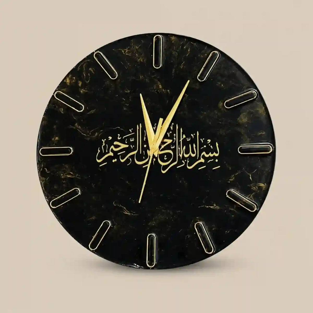 A round black marble-patterned wall clock with gold Arabic calligraphy at the center and gold hands, shown against a plain beige background.