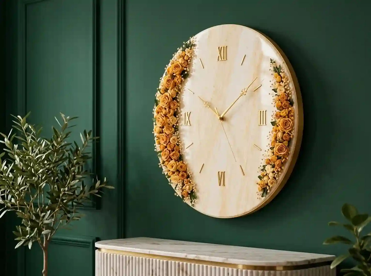 Round wall clock with a light wood grain face, gold Roman numerals, and dried floral arrangements in warm yellow and orange tones along the left and right sides, mounted on a dark green paneled wall above a console table.