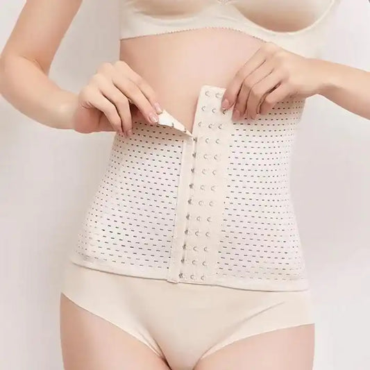 Person wearing a white waist trainer against a plain background