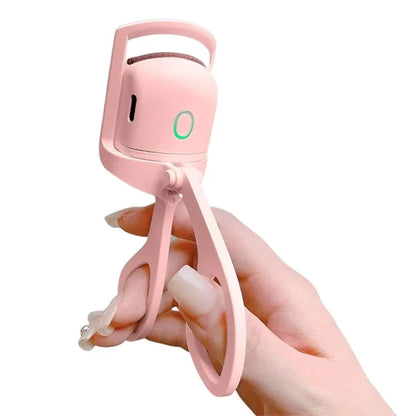 Pink handheld device with a strap held by a hand on a white background