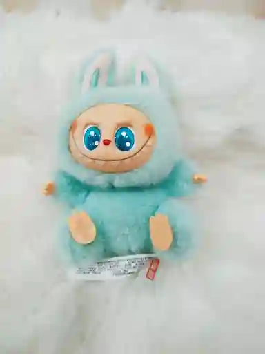 Toy with blue fur and large eyes on a white background