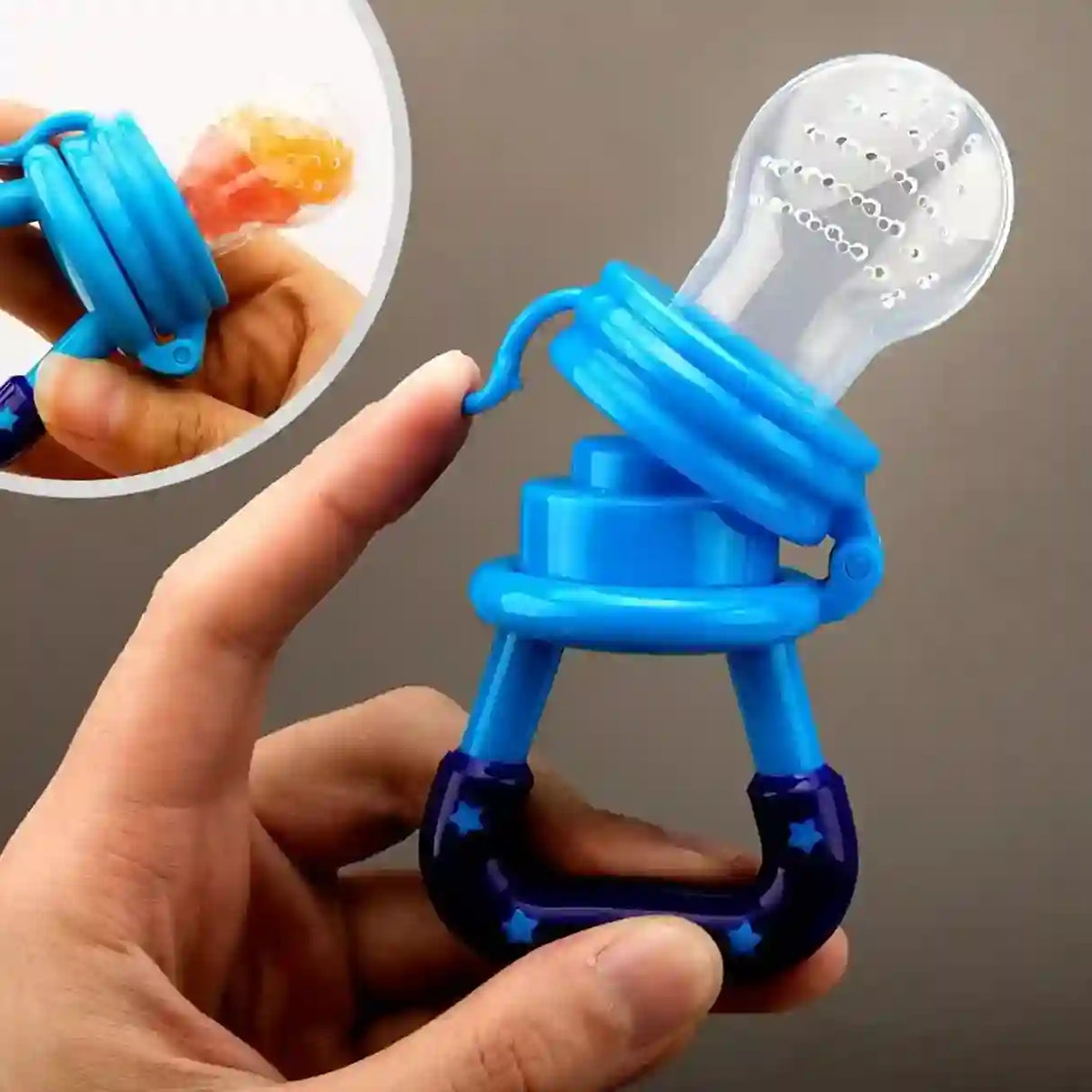 Blue and purple baby teether held in a hand with a close-up inset showing its texture.