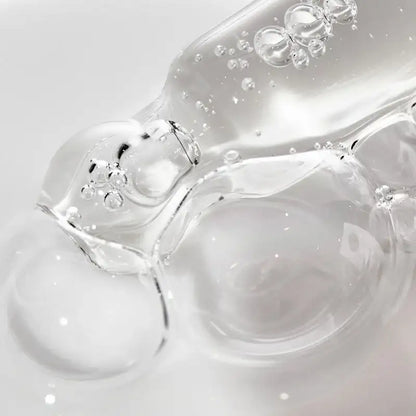Close-up of clear gel with bubbles on a light gray background