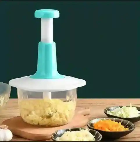 Vegetable chopper with chopped vegetables on a wooden table