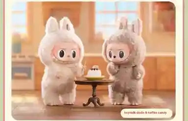 Two cute cartoon characters in bunny costumes standing next to a small table with a cake on it.