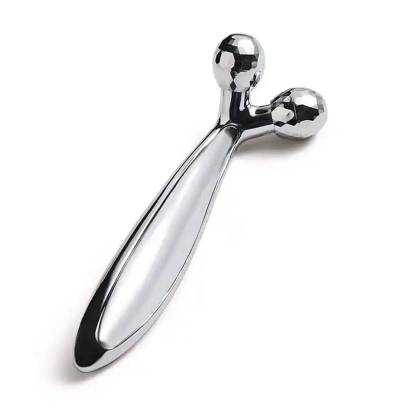 Metallic massage tool on a white background