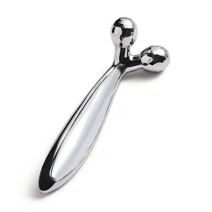 Metallic massage tool on a white background