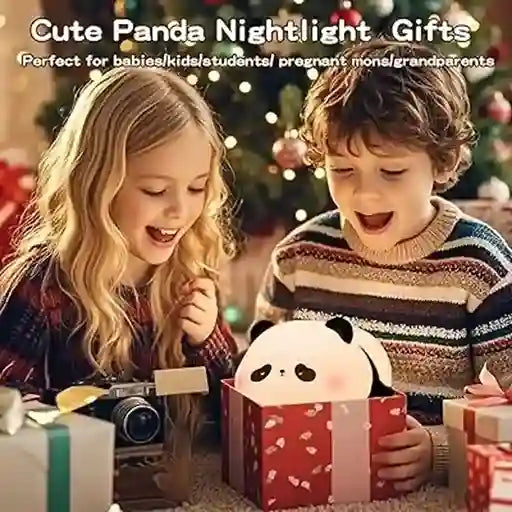 Two children opening a gift box with a panda nightlight inside, surrounded by Christmas decorations.