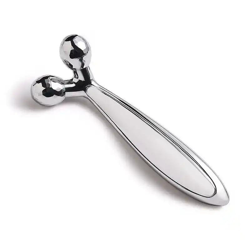Metallic massage tool on a white background