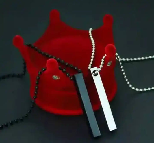 Three necklaces on a red stand against a dark background