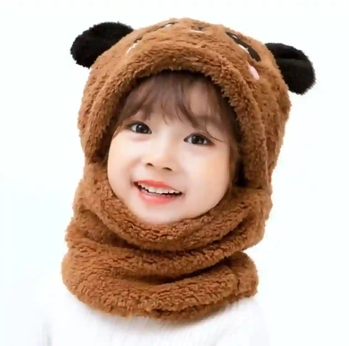 Child wearing a brown bear-themed hood and scarf on a white background