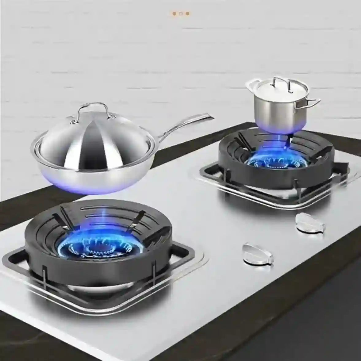 Two gas burners with pots on a kitchen counter