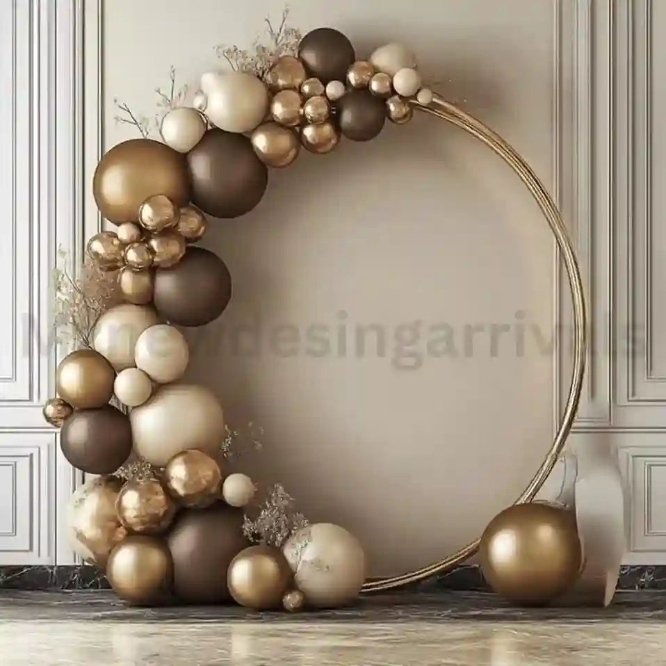 Decorative arch made of gold, brown, and beige balloons against a neutral wall.