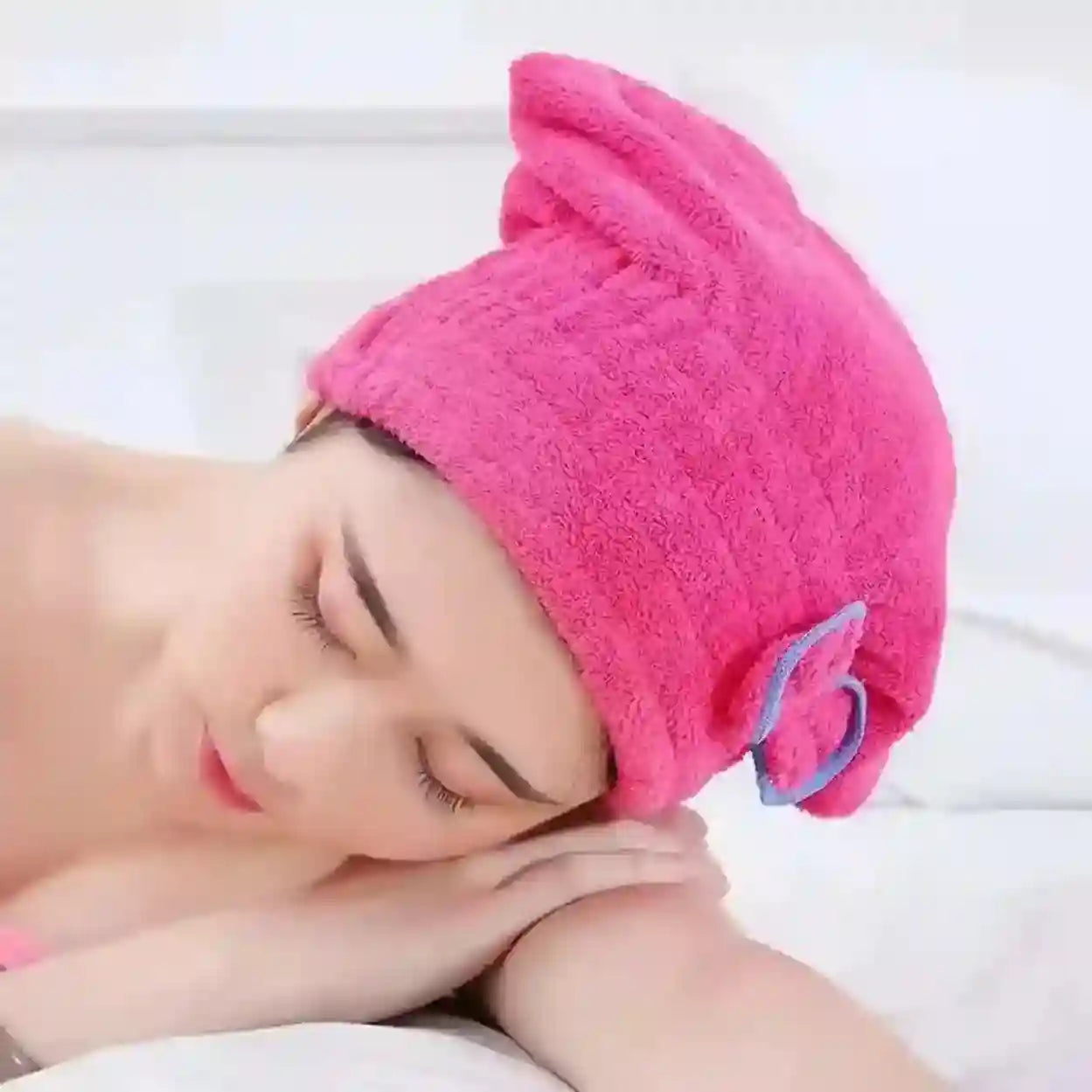 Person wearing a pink hair drying cap with a white background