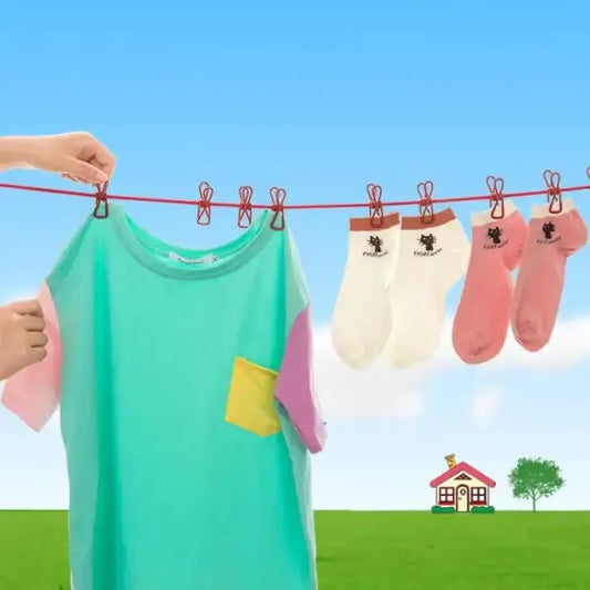 Colorful shirt and socks hanging on a clothesline with a cartoon house and tree in the background.