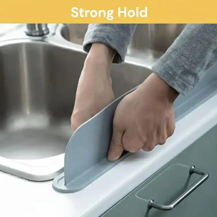 Person using a kitchen sink drain cover with 'Strong Hold' text above.