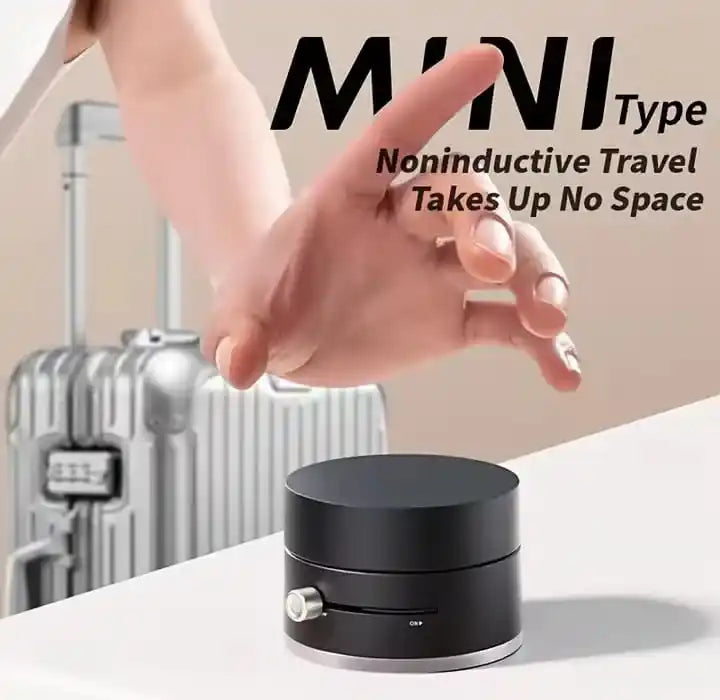 Black cylindrical device on a white surface with a hand reaching towards it, and text about noninductive travel.
