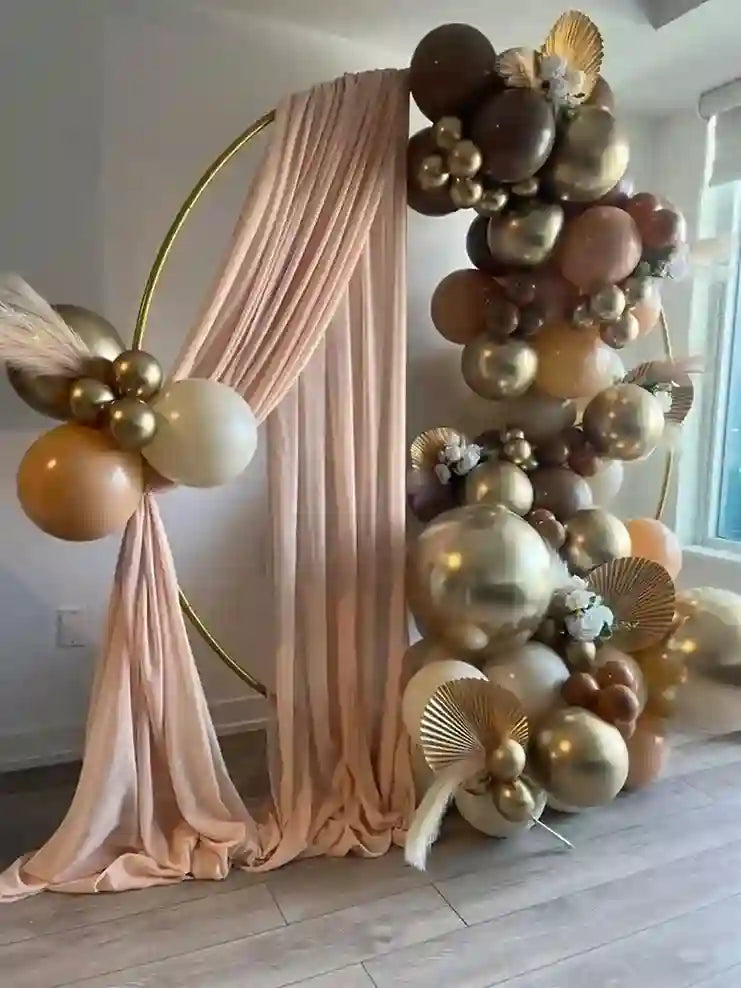 Decorative arch with balloons and fabric in a room setting