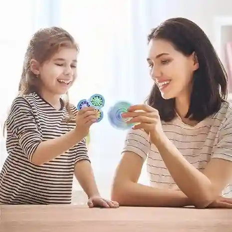 Woman and child playing with fidget spinners at a table