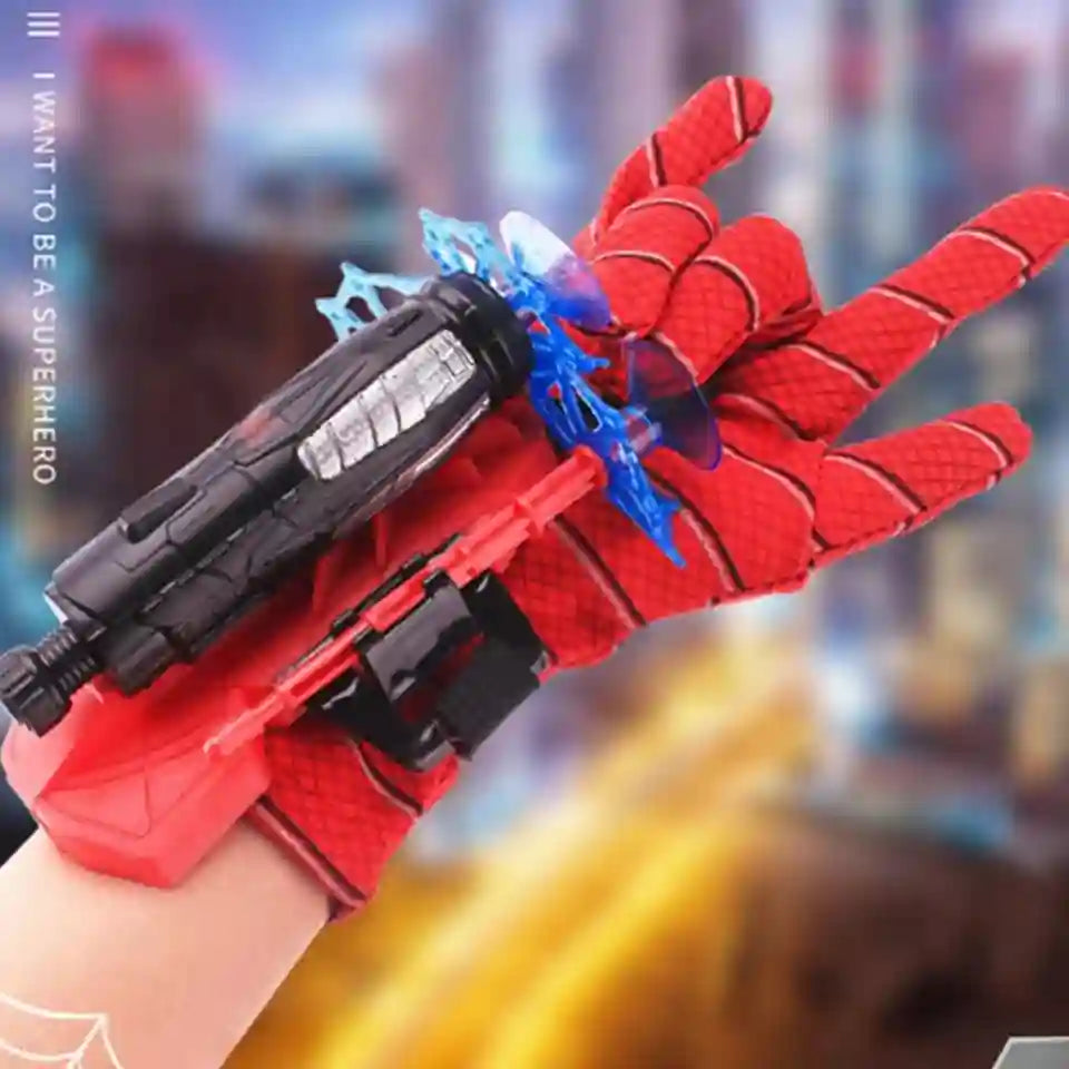 Red superhero glove with a weapon attachment against a blurred cityscape background