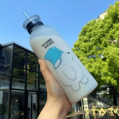 White water bottle with a cartoon bear design held outdoors