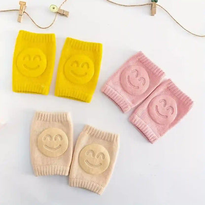 Four colorful knee pads with smiley face designs on a white background
