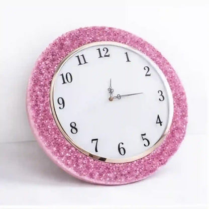 Pink glittery wall clock on a white background