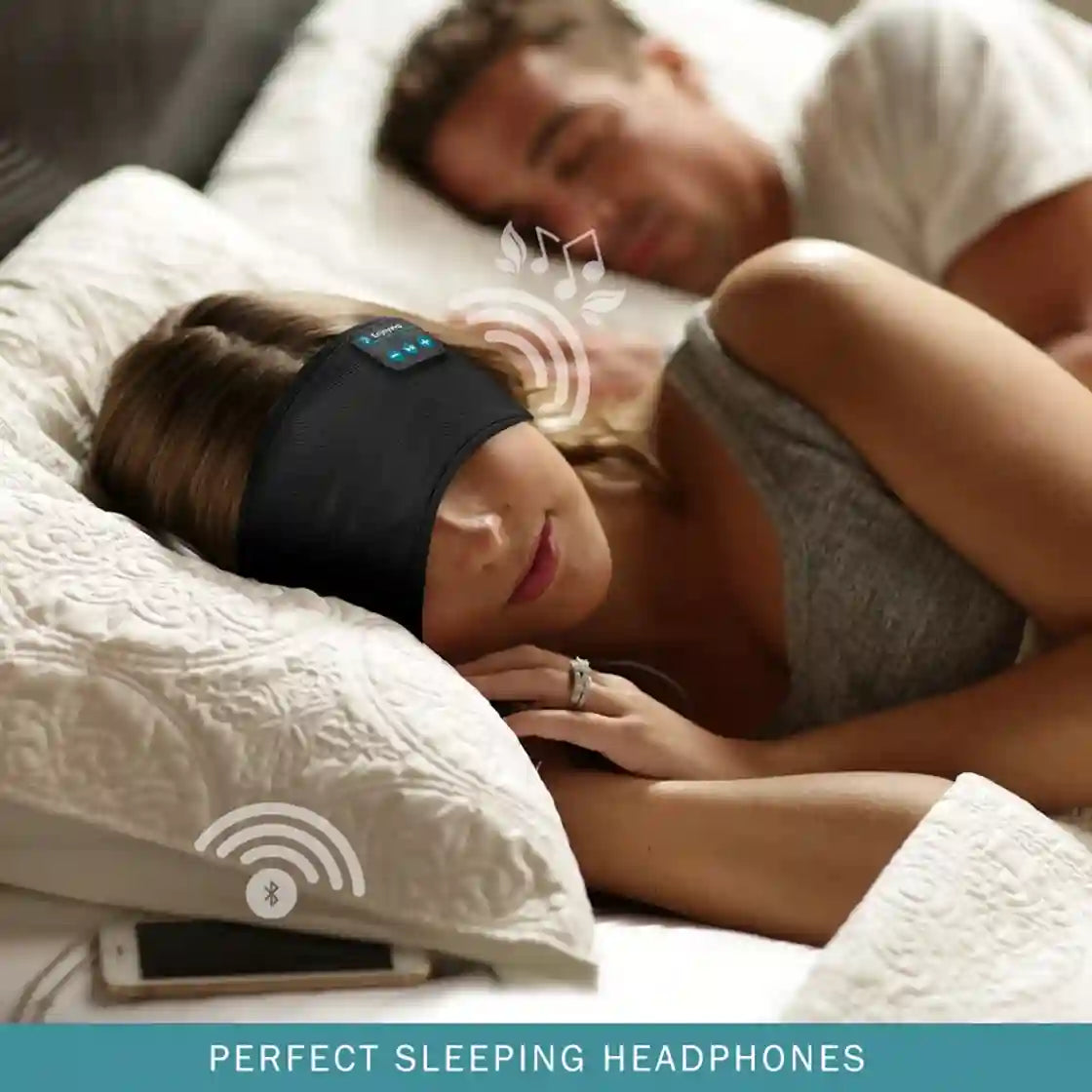 Woman wearing Bluetooth sleep headphones while lying in bed with a man.