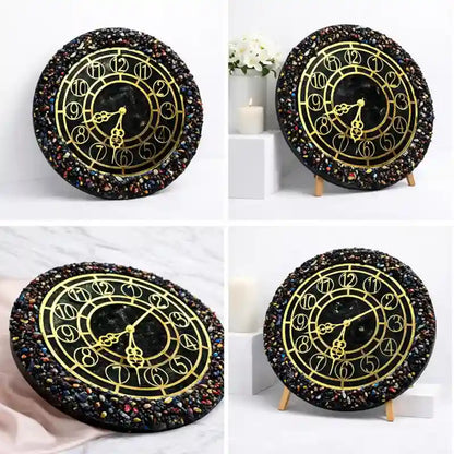 Decorative wall clock with black and gold design on a white background