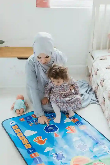 Woman and child playing on an interactive mat in a bedroom setting